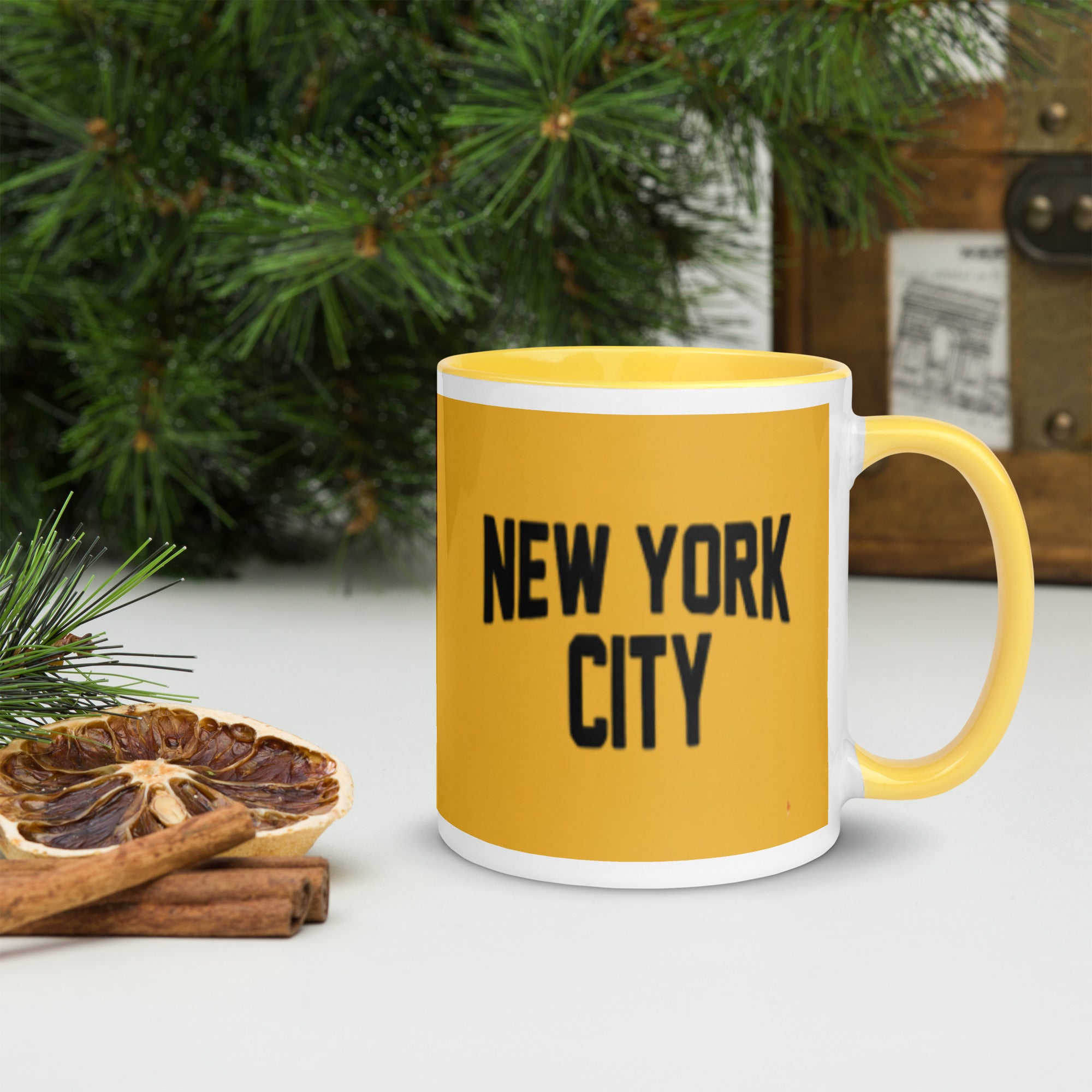 Yellow mug with 'New York City' text on a white surface with decorative elements.